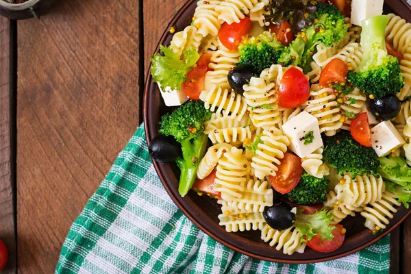 Pasta salad with tomatoes, broccoli, olives