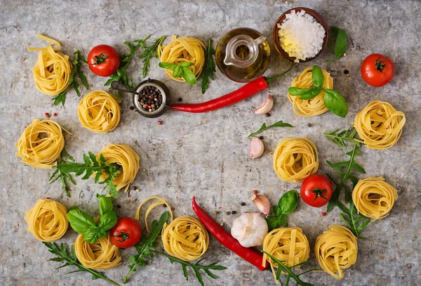 Pasta Tagliatelle nests and ingredients — Stock Photo, Image
