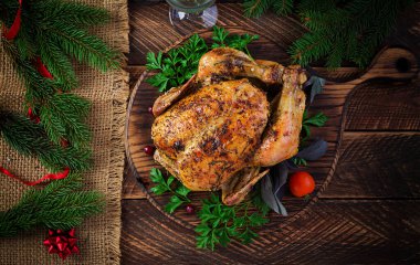 Fırında hindi ya da tavuk. Noel masası parlak süslemelerle süslenmiş bir hindiyle servis edilir. Kızarmış tavuk, sofra takımı. Noel yemeği. Üst görünüm, genel görünüm, kopyalama alanı