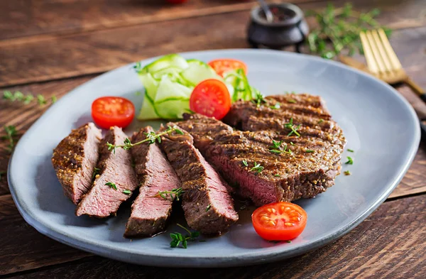 양념과 샐러드 곁들인 맛있는 스테이크 크기의 쇠고기 — 스톡 사진