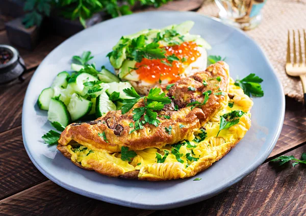Omelette with forest mushroom, fusilli pasta and sandwich wich red caviar, avocado on plate. Frittata - italian omelet. — Stock Image Omelette Forest Mushroom Fusilli Pasta Sandwich Wich Red Caviar Avocado Stock Picture
