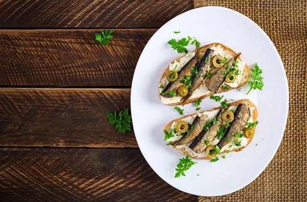 Sandwich Smorrebrod Sprats Green Olives Butter Wooden Table Danish Cuisine — Stock Photo, Image