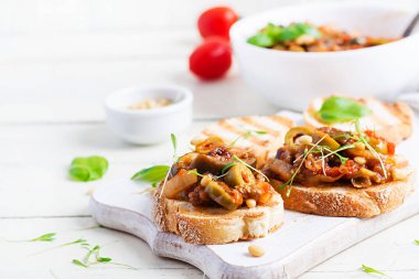 Geleneksel İtalyan Caponata ve tahta beyaz bir masada tost. Sicilya Caponata.