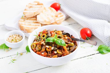 Geleneksel İtalyan Caponata ve tahta beyaz bir masada tost. Sicilya Caponata.