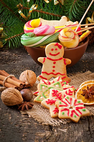 Gingerbread cookies and lollipops in bowl — Stock Photo, Image