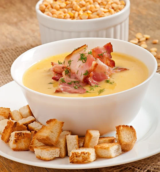 Cream soup of peas with fried bacon and croutons — Stock Image Cream soup of peas with fried bacon and croutons Stock Photo