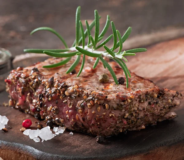 Raw beef steak with spices — Stock Photo, Image