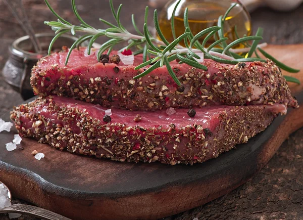 Raw beef steak with spices — Stock Photo, Image