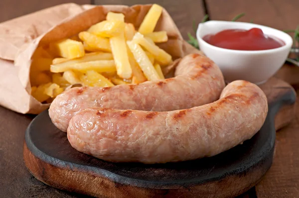 Chicken sausages with french fries — Stock Photo, Image