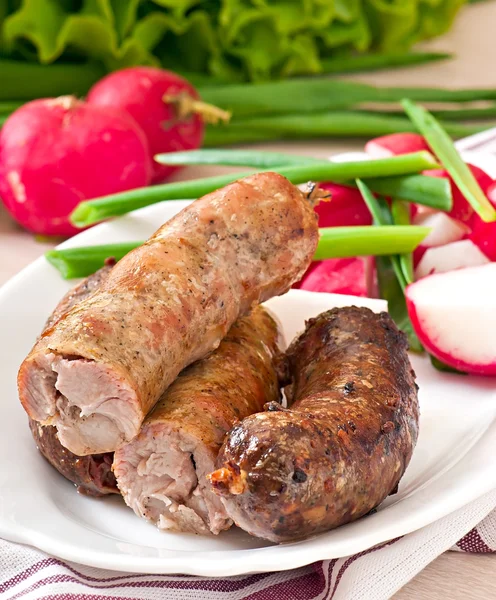 Homemade sausages baked in the oven and salad — Stock Photo, Image