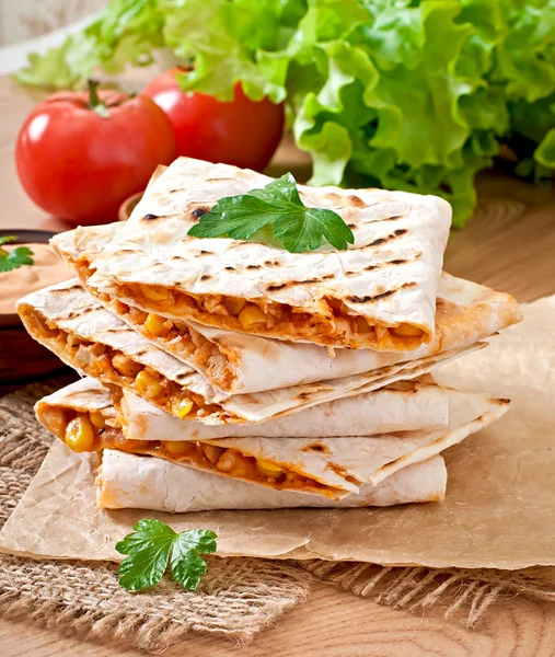Mexican Quesadilla sliced with vegetables and sauces on the table — Stock Photo, Image