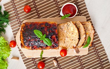 Meatloaf with ketchup and basil. clipart