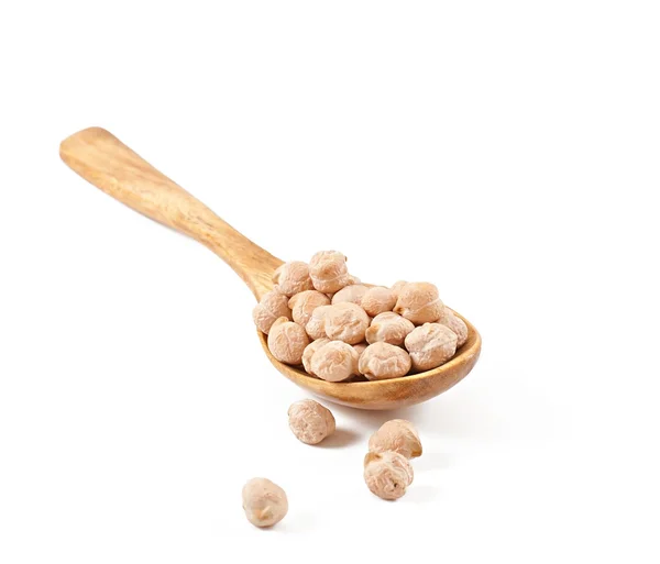 Uncooked chickpeas in wooden spoon — Stock Photo, Image