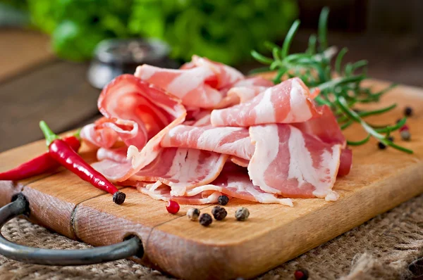 Slices of bacon  with spices — Stock Photo, Image