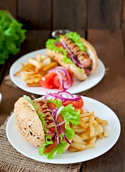 Cachorros-quentes com batatas fritas e legumes — Fotografia de Stock