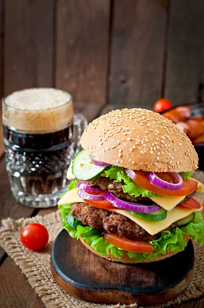 Velký hamburger s masem a zeleninou a pivo — Stock fotografie