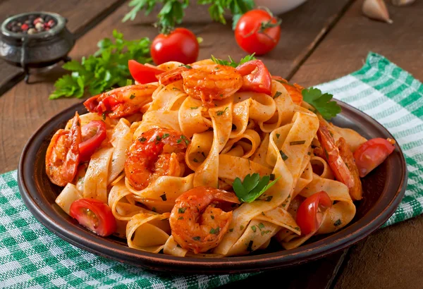 Fettuccine pasta con gambas, tomates y hierbas . — Foto de Stock