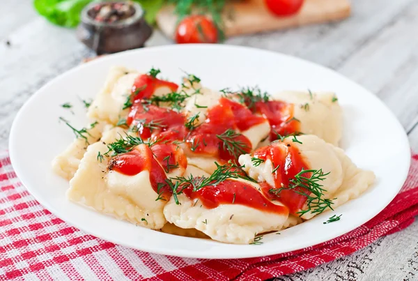 Delicious ravioli with tomato sauce and dill — Stock Photo, Image