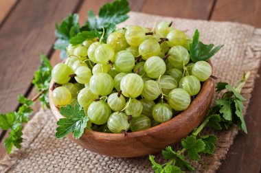 Ripe gooseberries in a plate clipart