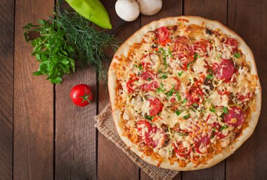 Pizza with tomatoes, salami ,cheese  and vegetables
