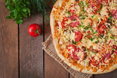 Pizza with tomatoes, salami ,cheese  and vegetables