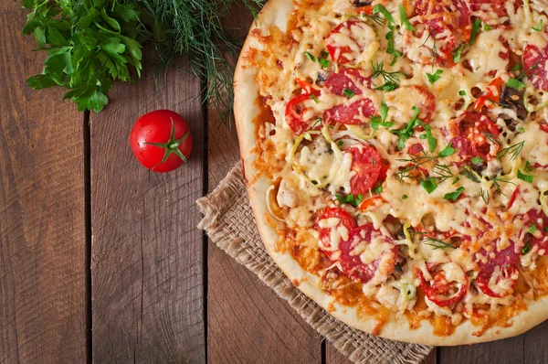 Пицца с помидорами, салями, сыром и овощами — стоковое фото