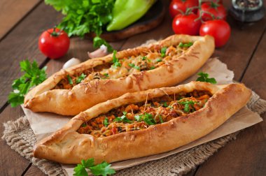 Turkish pides with beef and vegetables clipart