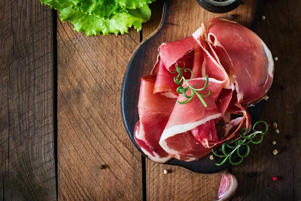 Slices of Prosciutto with spices — Stock Photo, Image