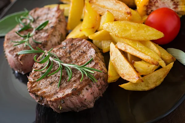 Bifes com batatas fritas e legumes — Fotografia de Stock