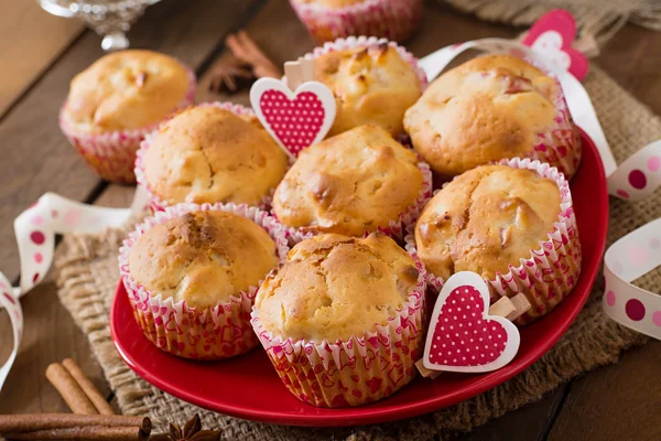 Tasty muffins with cinnamon and hearts — Stock Photo, Image