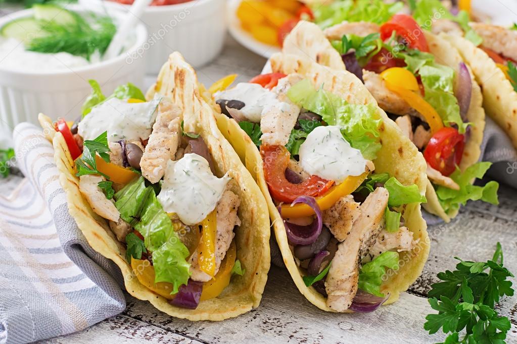 Mexican tacos with chicken, bell peppers, black beans and fresh