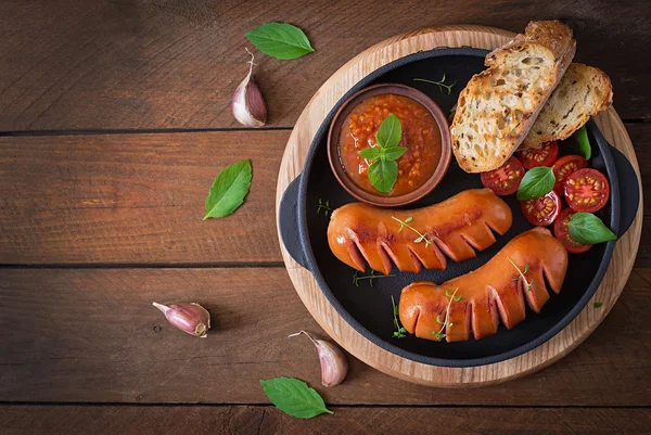 Sausages on the grill with vegetables