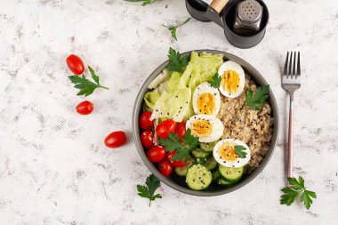 Healthy breakfast Bowl of oatmeal and fresh vegetables. Top view. Overhead
