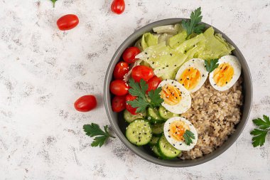 Healthy breakfast Bowl of oatmeal and fresh vegetables. Top view. Overhead