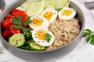 Healthy breakfast Bowl of oatmeal and fresh vegetables.