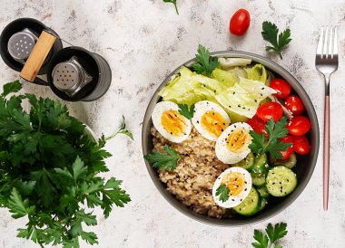 Healthy breakfast Bowl of oatmeal and fresh vegetables. Top view. Overhead