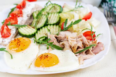 Ketogenik, paleo diyeti. Kızarmış yumurta, haşlanmış tavuk ve taze salata. Keto kahvaltısı. Kahvaltı.