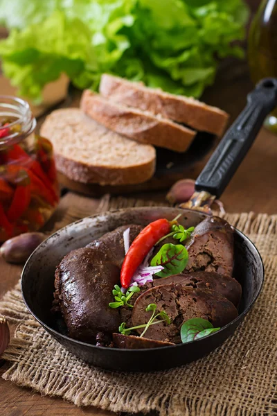Homemade blood sausage with offal on the old wooden background in rustic style — Stock Photo, Image