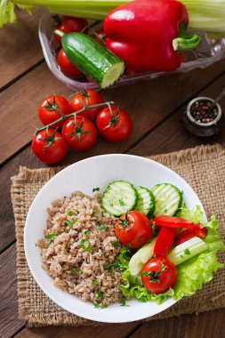 Porridge with fresh vegetables and lettuce. Healthy breakfast. Proper nutrition. Dietary menu.