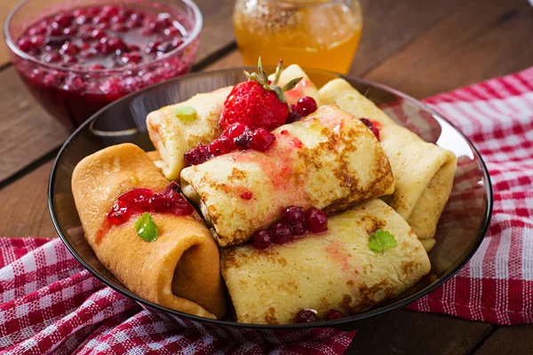 Golden pancakes with cranberry jam and honey in a rustic style. — Stock Photo, Image