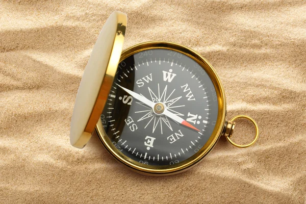 Golden vintage compass on sand — Stock Photo, Image