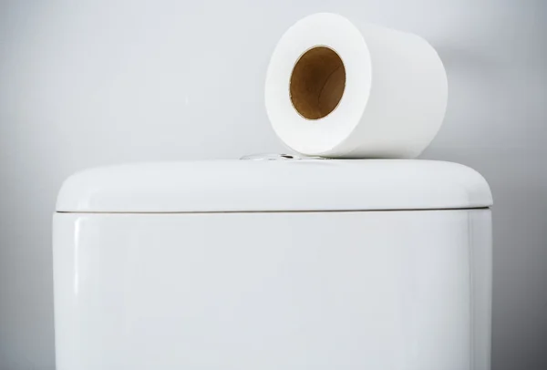 Hygienic paper on white toilet tank — Stock Photo, Image