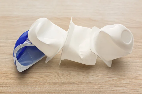 Empty crushed plastic yogurt pots — Stock Photo, Image