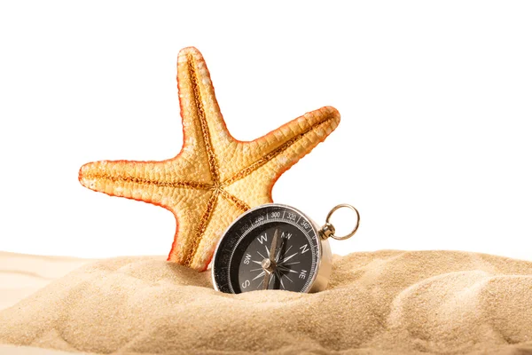 Sjøstjerne og kompass i sand – stockfoto