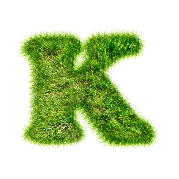 Letter K gemaakt van groen gras — Stockfoto