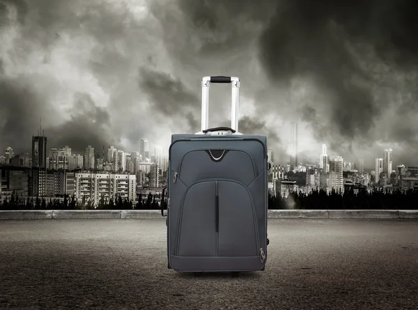 Suitcase on stormy sky background — Stock Photo, Image