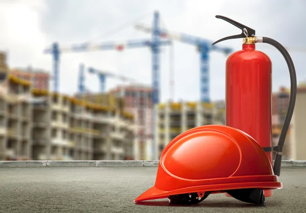 Fire extinguisher and helmet — Stock Photo, Image