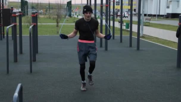 Чоловік тренується на відкритому повітрі на спортивному полі — стокове відео
