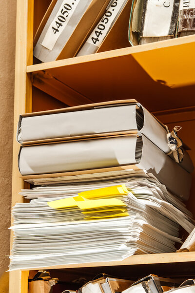 Stack of paper in bookcase