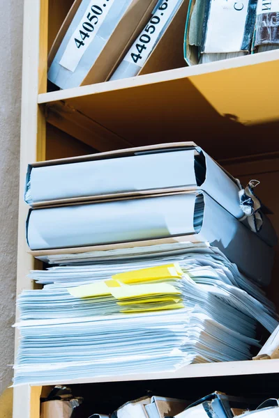 Stack of paper in bookcase — Stock Photo, Image